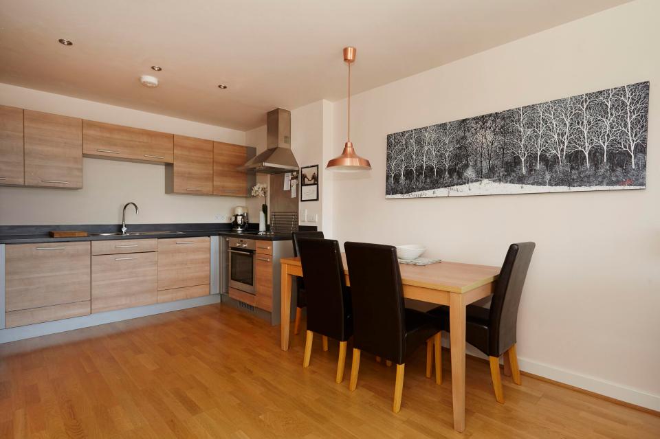  The recently refurbished kitchen is decked out in tasteful wood panelling