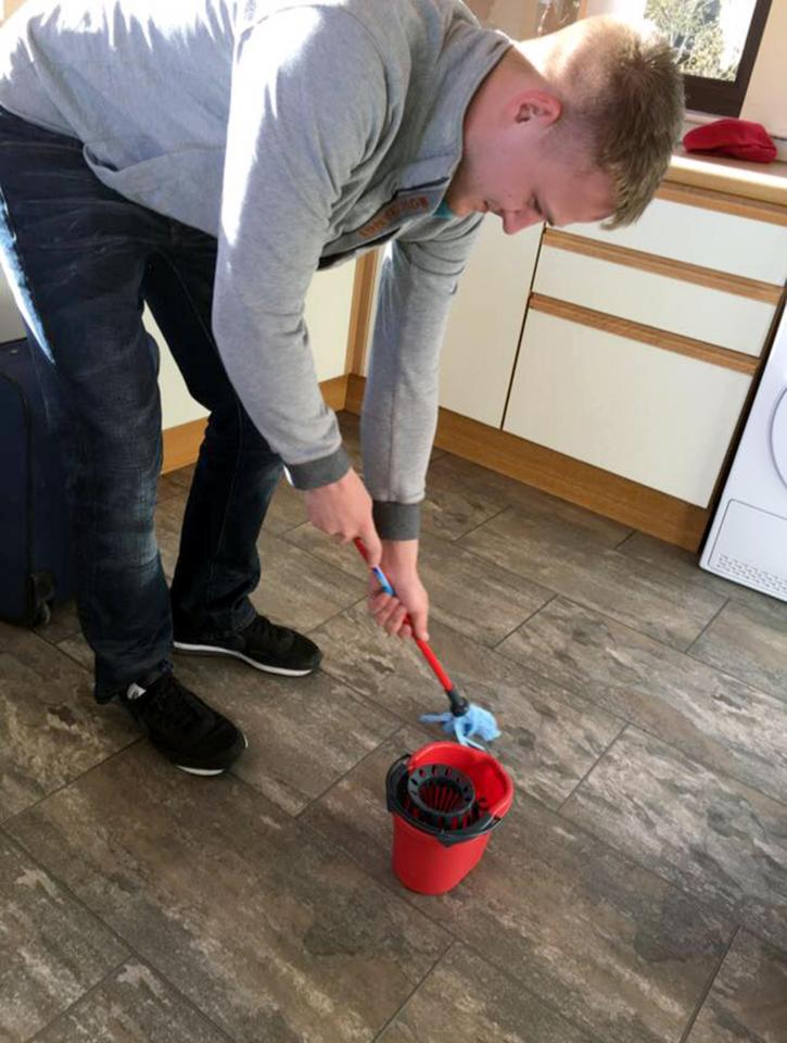  Wallace Kennedy stoops to clean the floor after ordering a toy mop and bucket by mistake