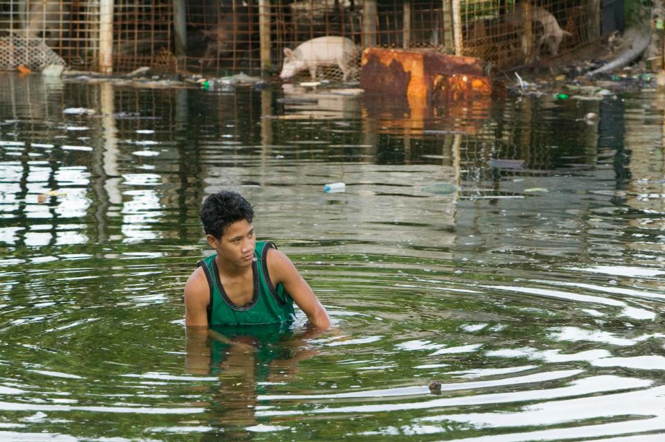  A young man wades through floodwater in low-lying Funafuti, Tuvalu