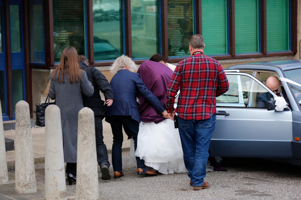 Paula Williamson is ushered into HMP Wakefield with her wedding entourage today