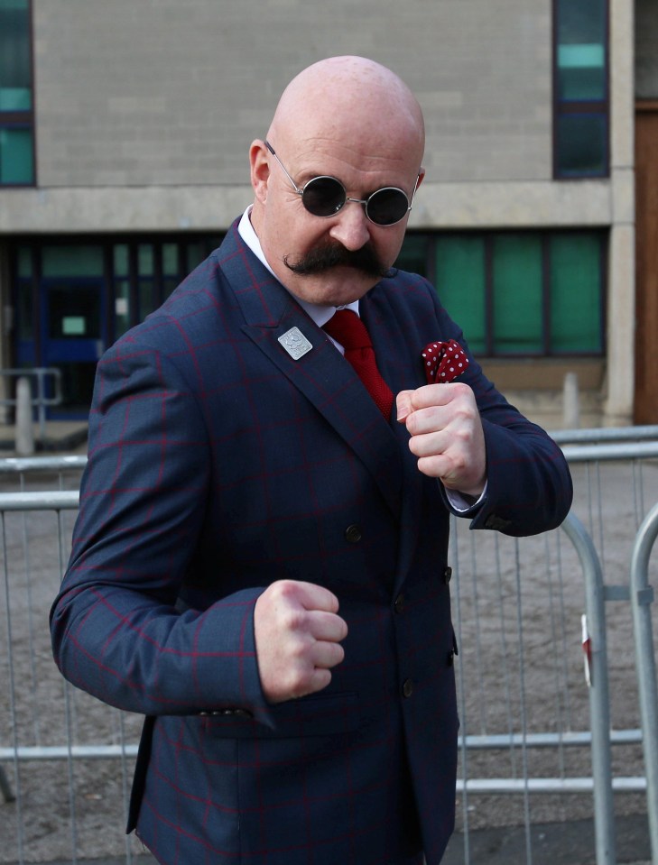 A Charles Bronson lookalike poses for photos outside the prison where the lag is marrying his soap star bride