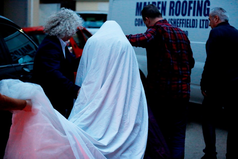 The ghostly cloak covered her dress from view after she wed Britain’s most violent lag today