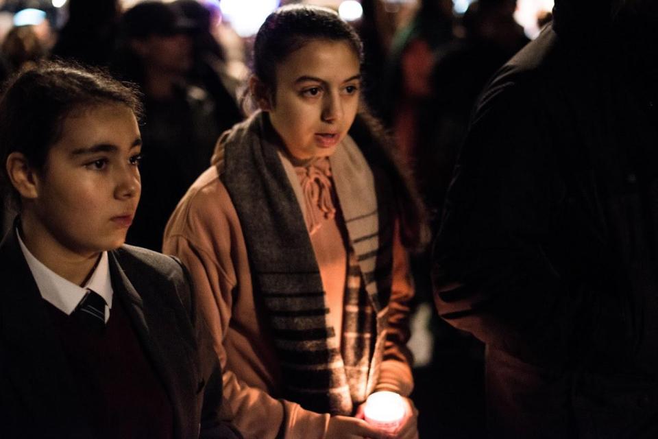  Supporters lit candles to remember the dead, thought to number at least 80