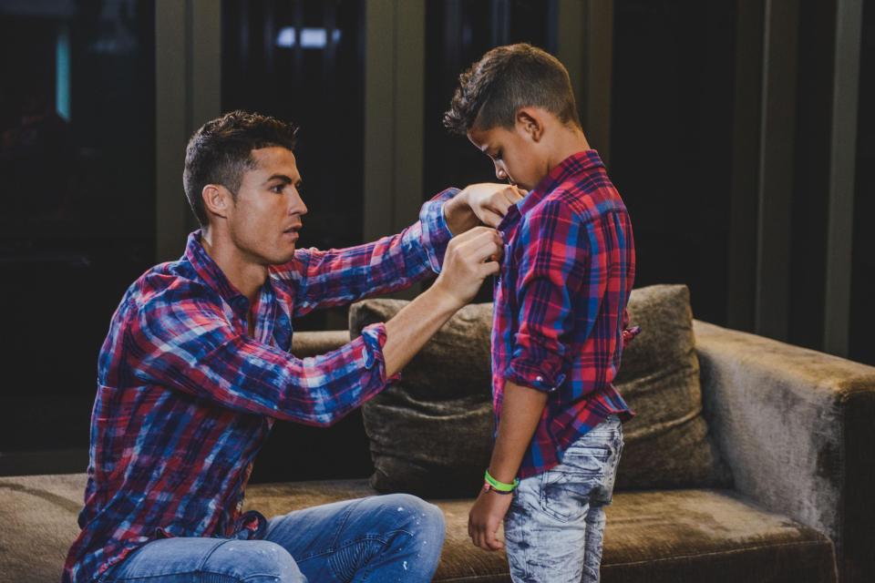  The father-son duo strike a pose in matching shirts