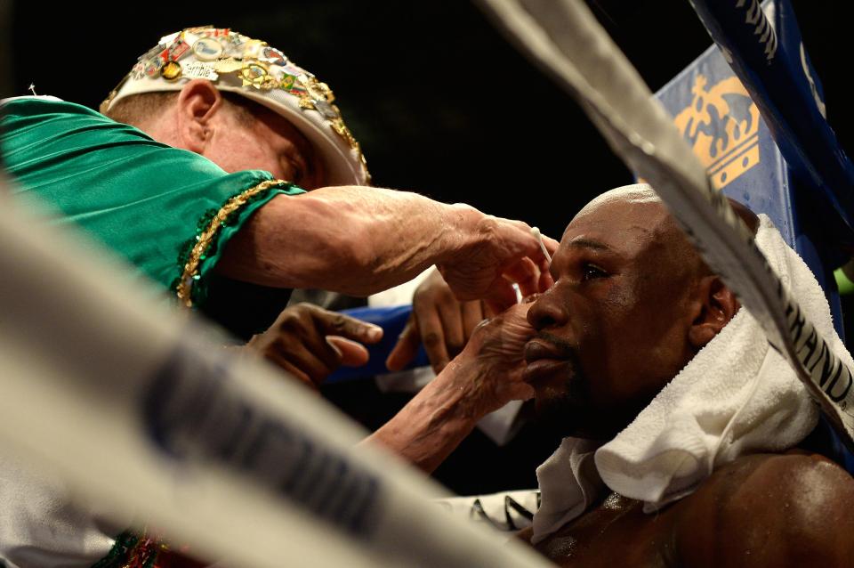  Garcia works on a cut above Mayweather eye during a fight with Marcos Maidana in 2014