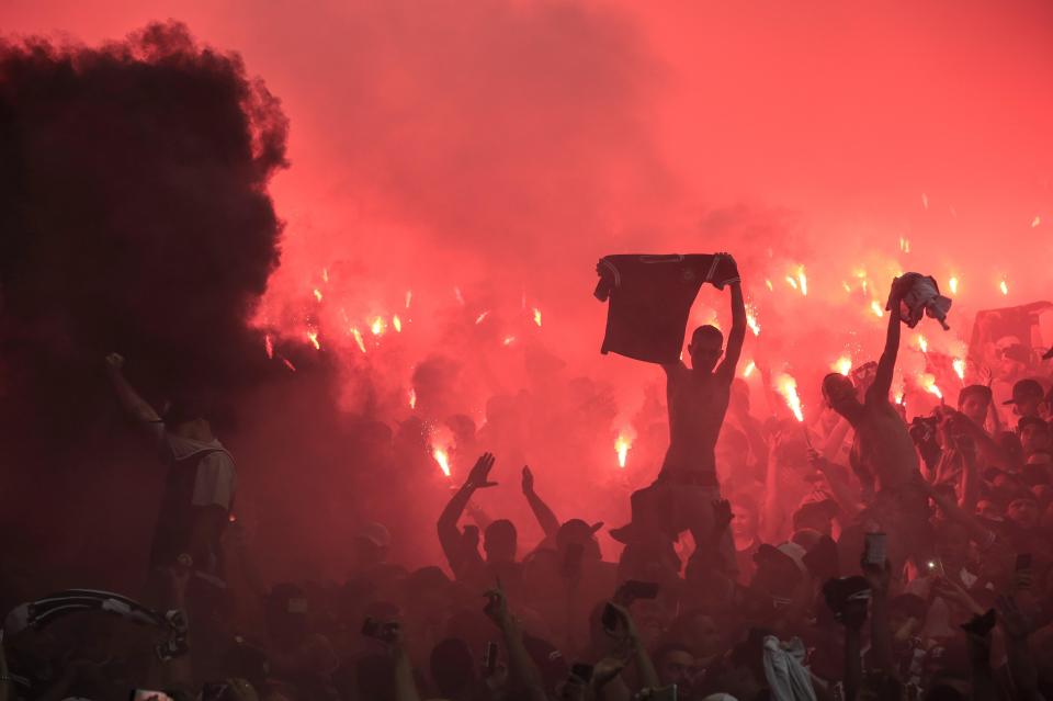  The stadium is lit up red as Corinthians fans celebrated with flares