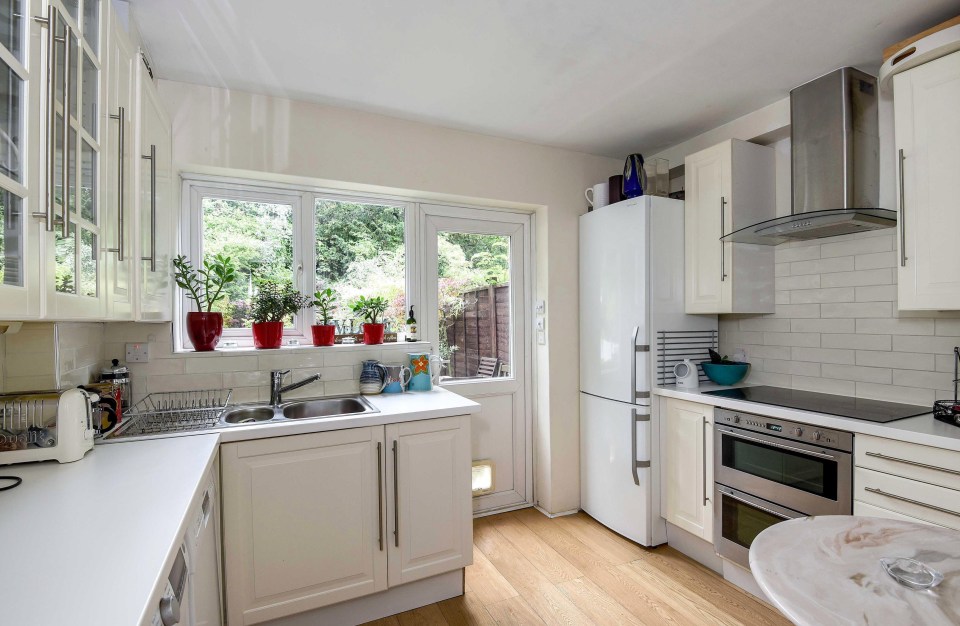 The light and airy home boasts a smart, white kitchen