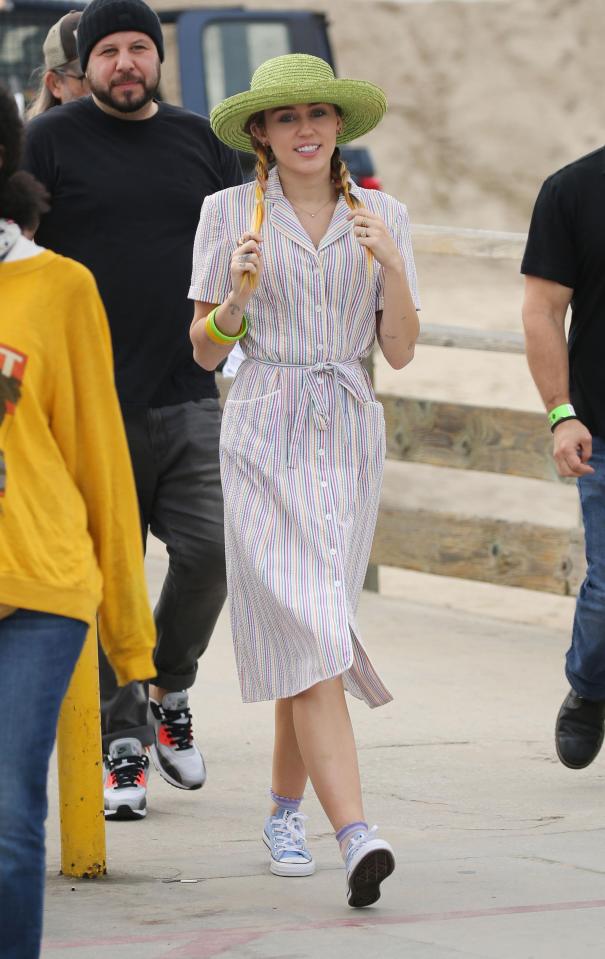  Miley was later seen filming in a prim retro dress and lime hat