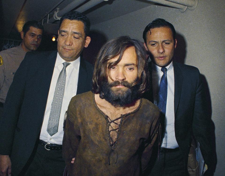 Manson is taken in cuffs to a US courtroom in 1969 on conspiracy-murder charges