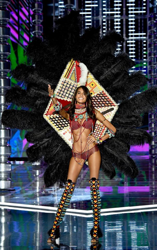  Cindy Bruna modelled a pair of gigantic black feather wings as well as colourful beaded accessories and thigh-high heels