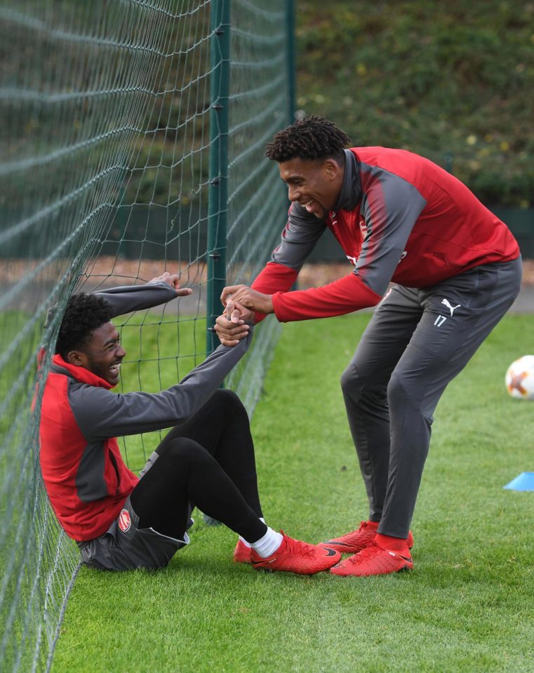  Ainsley Maitland-Niles and Alex Iwobi share a joke during Arsenal training