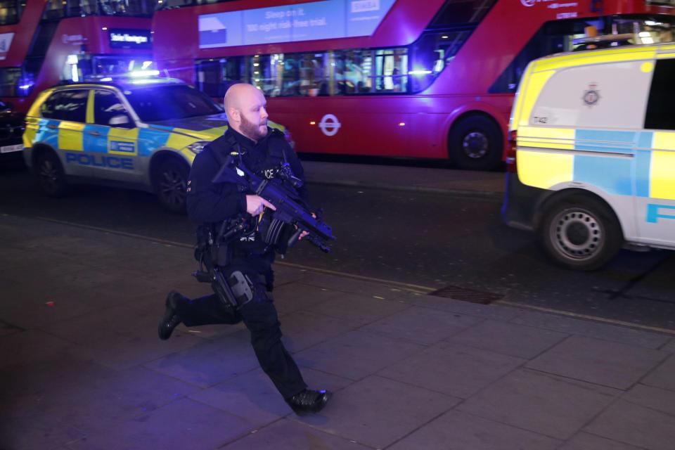  An armed officer runs down Oxford Street