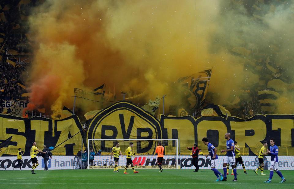  Dortmund fans let off yellow smoke bombs during the Bundesliga clash