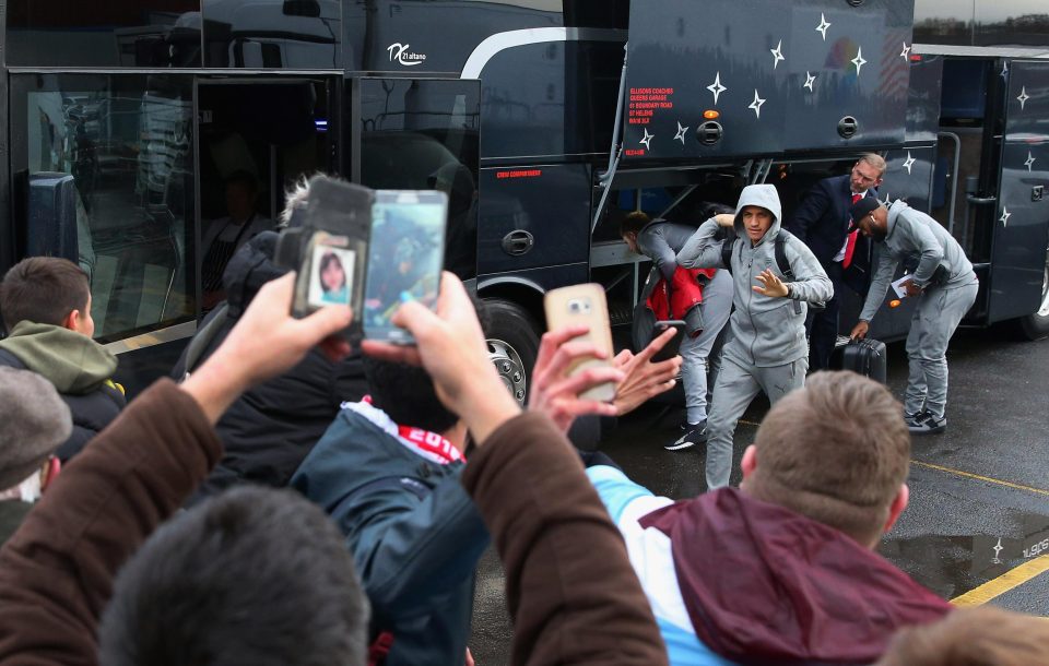  Fans surround the Arsenal team bus as it arrives