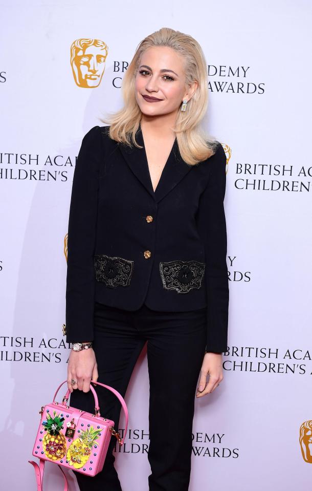  Pixie Lott looked gorgeous in a tailored black suit with a colourful pineapple bag