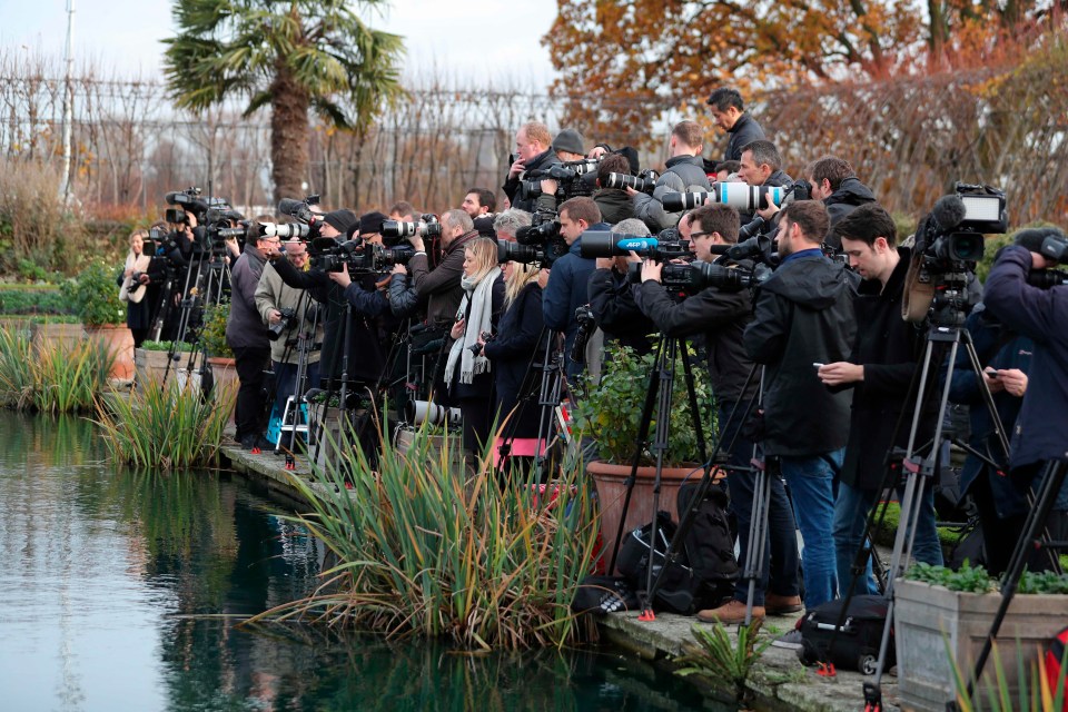 The world’s press gather outside of Kensington Palace where Prince Harry and Meghan Markle will arrive for a photo shoot later today