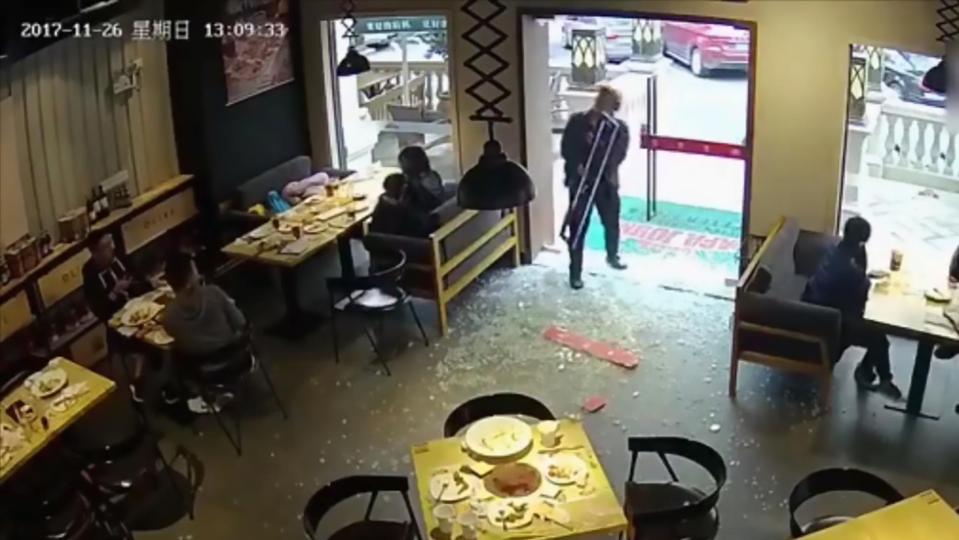  Slapstick delivery man looks up quizzically after he is left holding the handle with no door attached