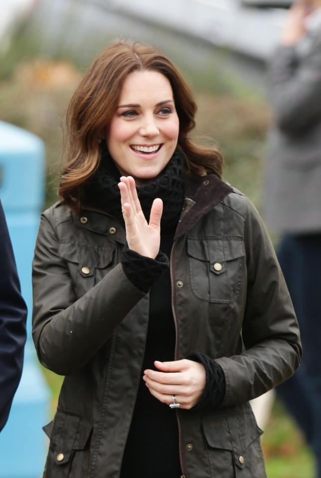  Pregnant Kate Middleton wrapped up against the winter chill in a Barbour jacket today on a visit to a school