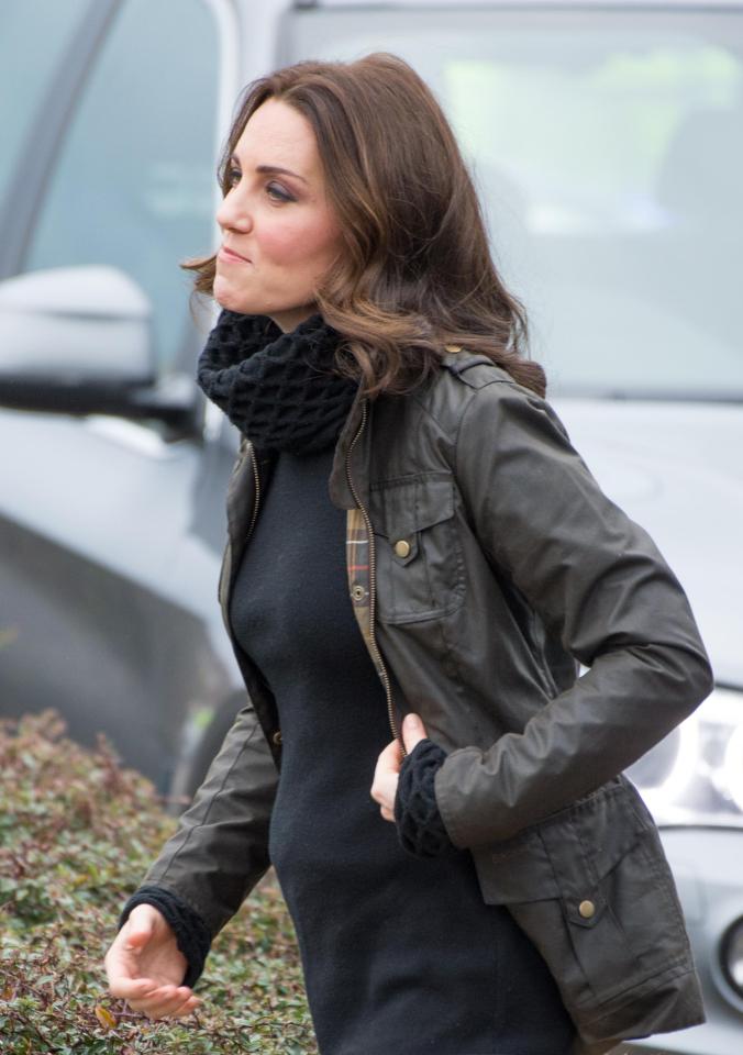  Kate displayed her growing baby bump on a school visit this morning