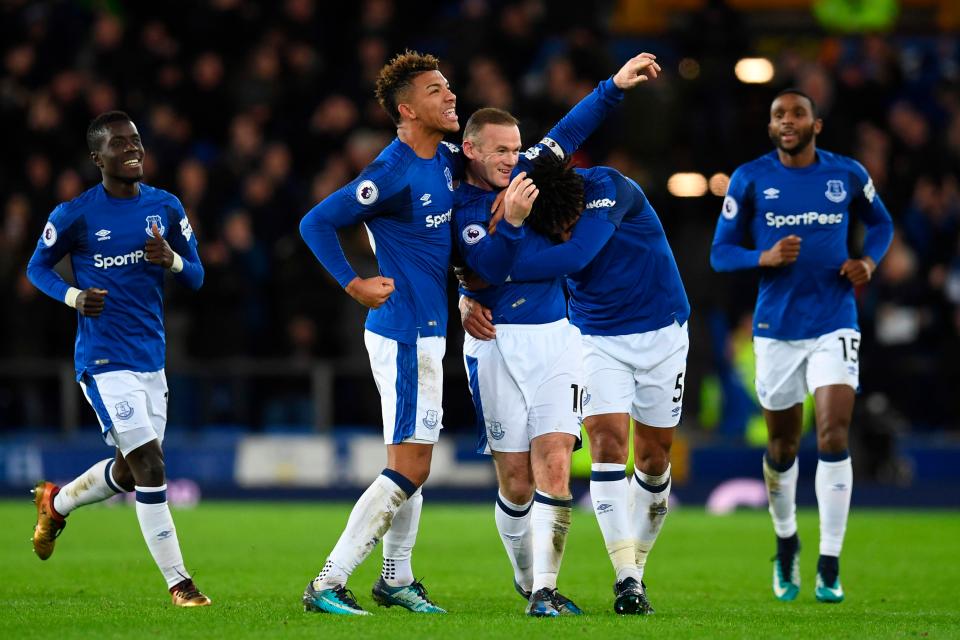  Rooney was mobbed by team-mates after his stunner