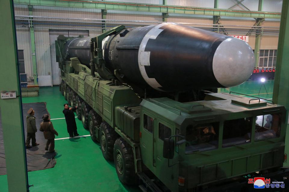  Kim inspects the new rocket, which has a reported range of over 8,000 miles