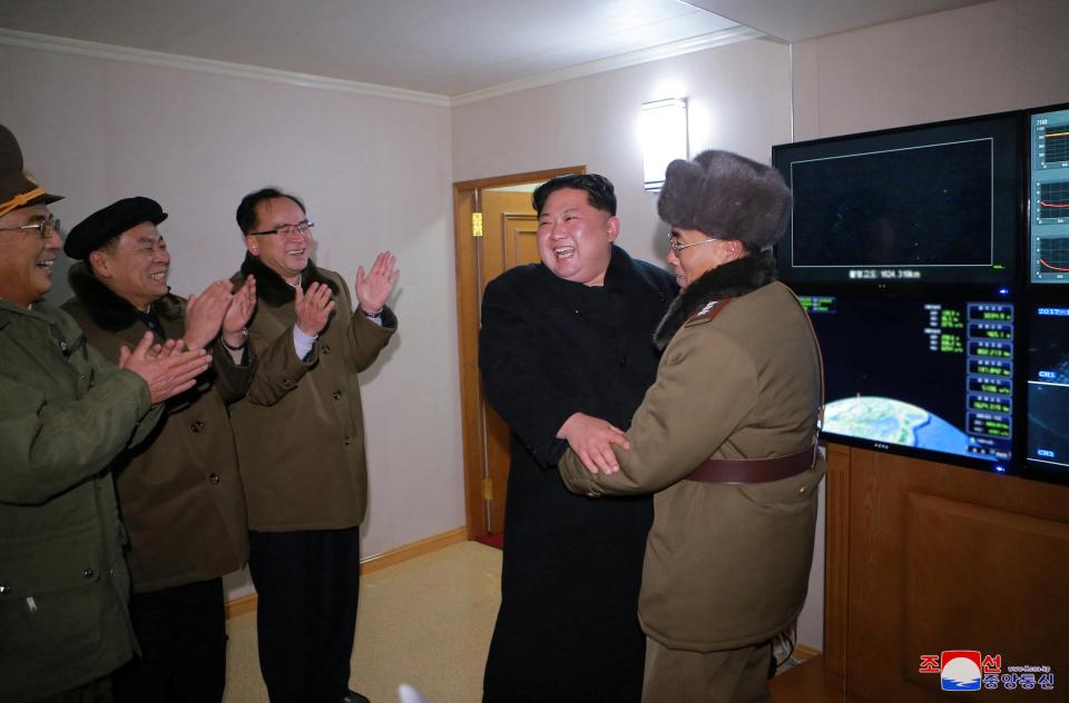  Kim was pictured cackling with his generals after the successful launch