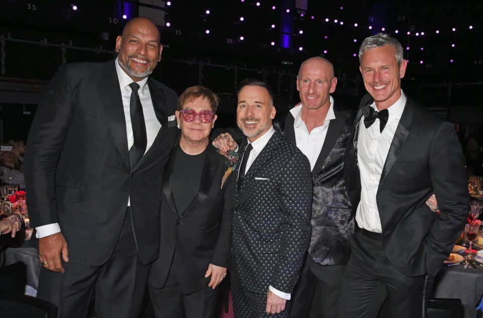  Elton John struck a pose with partner David Furnish and athletes Gareth Thomas, Mark Foster and John Amaechi