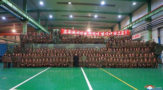  Those behind the launch line up for a bizarre team photo with Kim