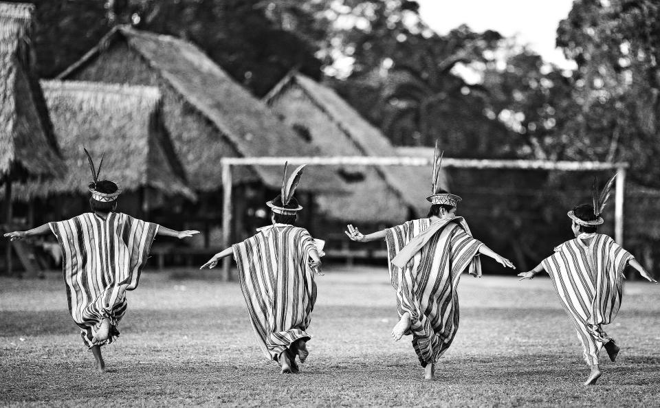  Ashaninka children appear to run towards a makeshift goal post in Apiwtxa village