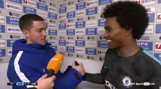  Willian is at first bewildered but then takes the award and shakes Eden Hazard's hand