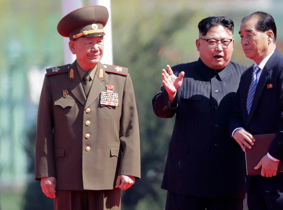  Hwang Pyong-so, left, stands near North Korean leader Kim Jong-un during the opening ceremony of a residential area in 2013