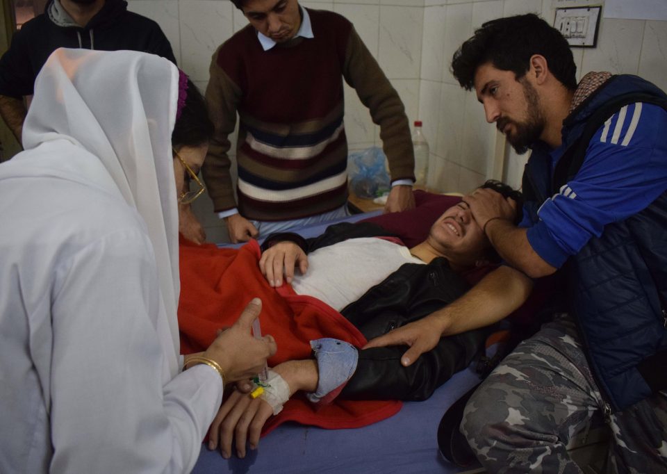 Nurse tends an injured victim following the attack on Peshawar Agricultural Training Institute