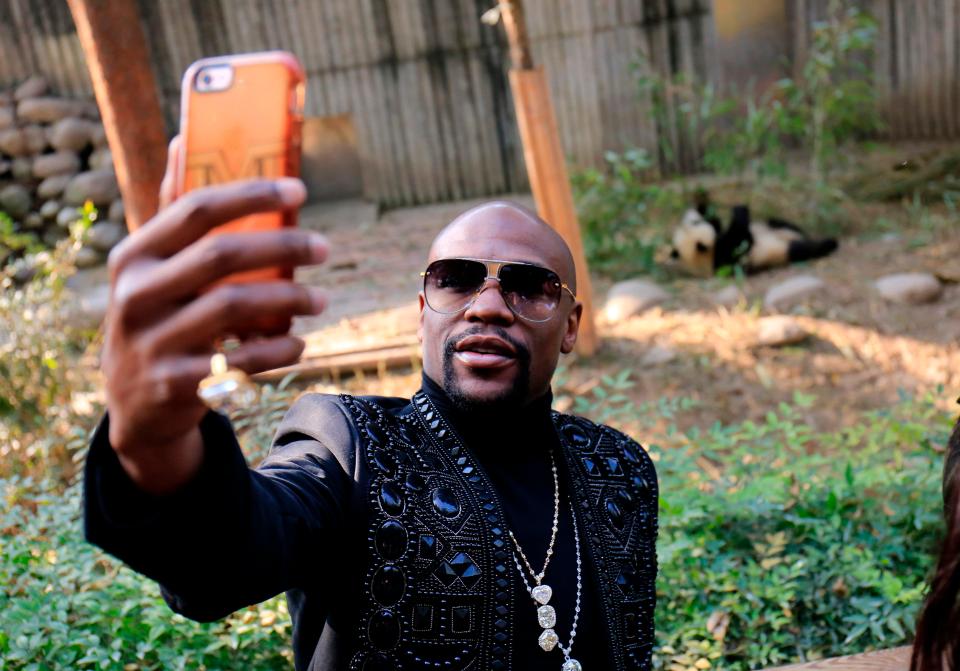  Floyd Mayweather poses for a selfie with his adopted giant panda in China