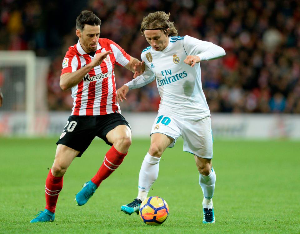  Luka Modric sprints away from Aritz Aduriz at the San Mames stadium