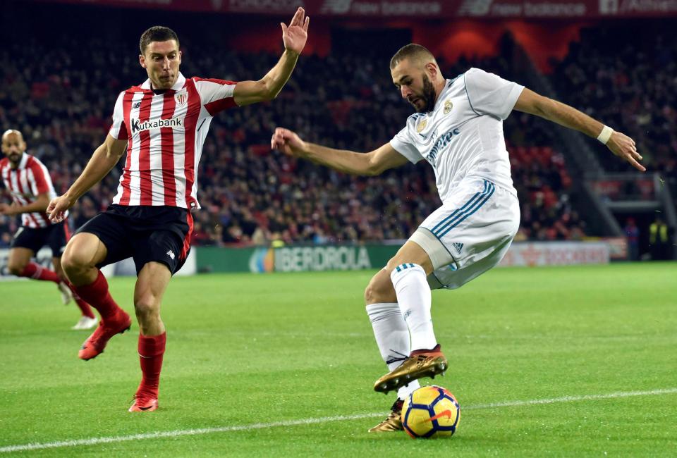  Karim Benzema vies for the ball against Oscar De Marcos