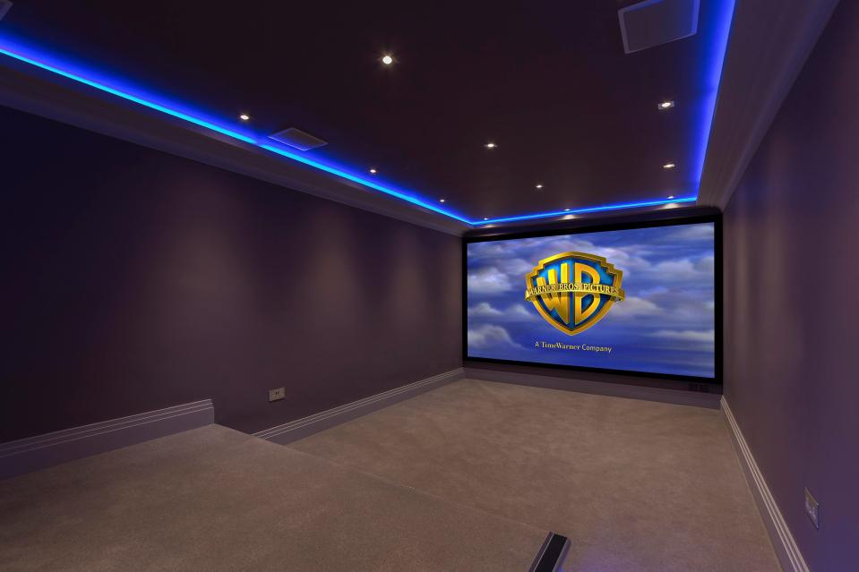  The lower ground floor cinema room boasts a giant screen