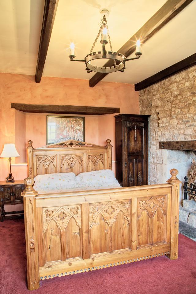  A grand wooden bed stands in one of the five bedrooms