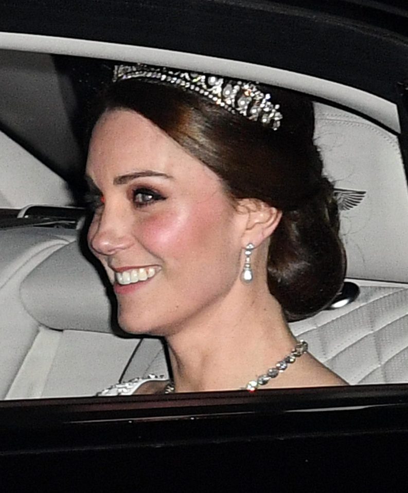  The Duchess of Cambridge is pictured smiling in the back of her chauffeur driven car on her way to a Buckingham Palace event wearing a tiara loved by Diana