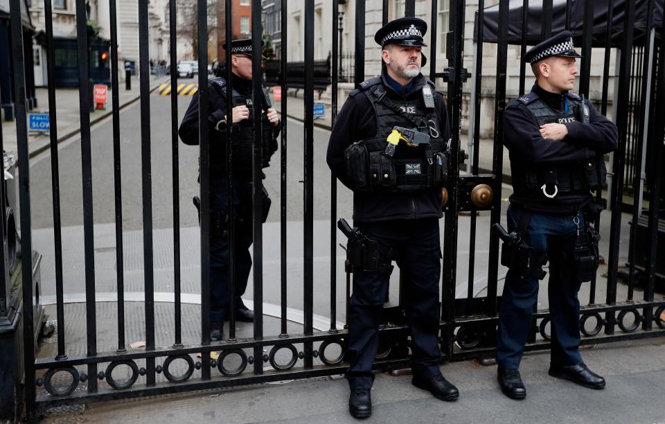  Police officers guard the gates to Downing Street in London today