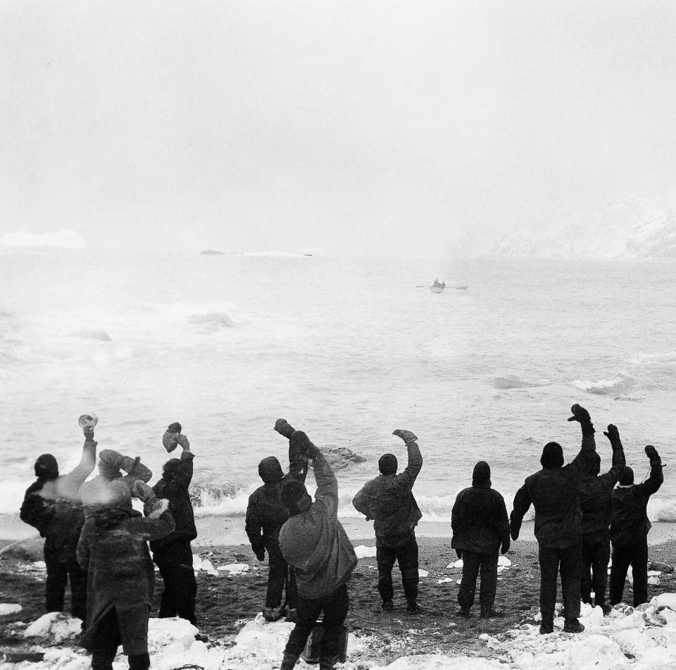  With a rescue boat approaching them crew members rejoice