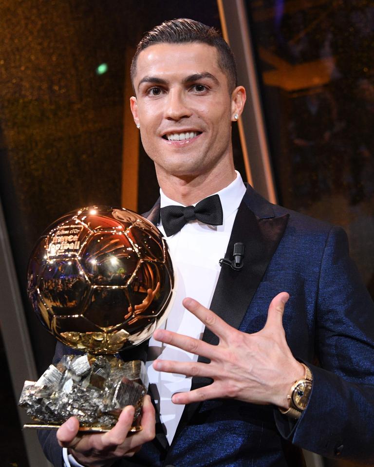  Cristiano Ronaldo flashes a smile with his fifth Ballon d'Or award