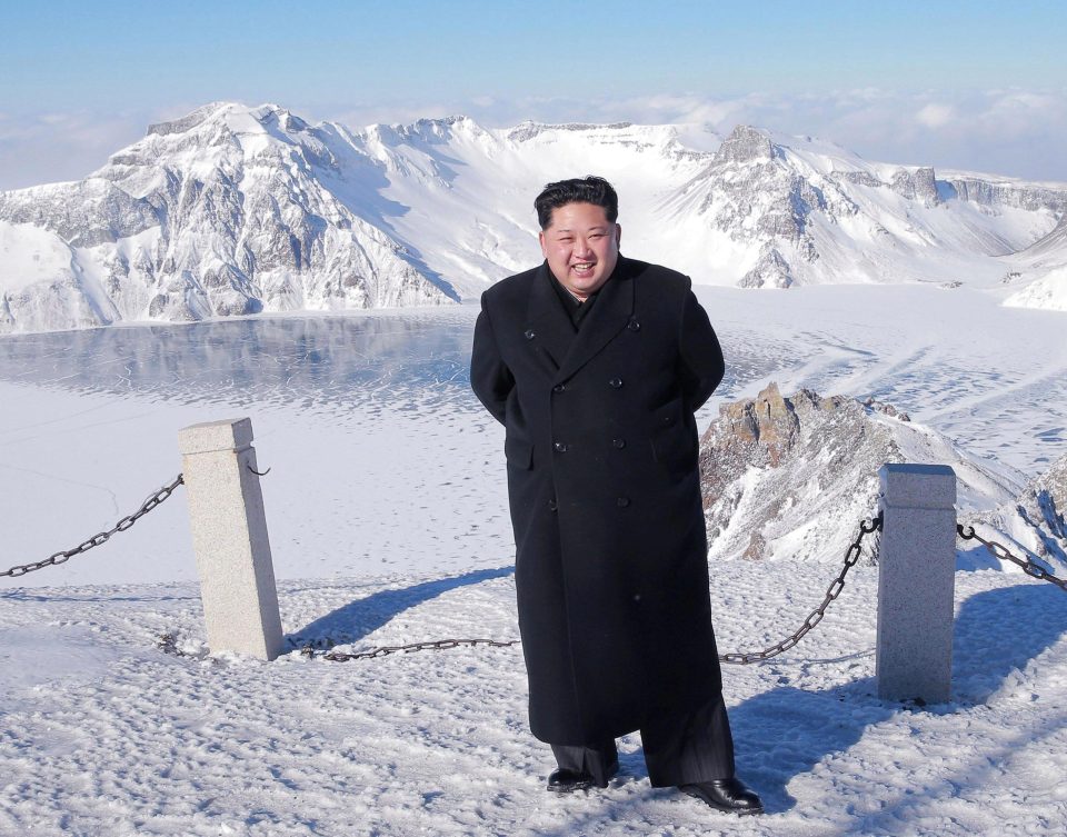  Kim beams at the peak of the mountain in his formal wear