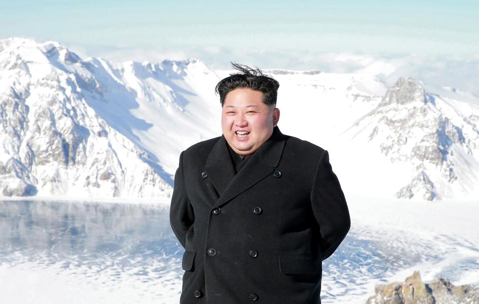  The double-chinned despot chuckles after 'climbing' the mountain