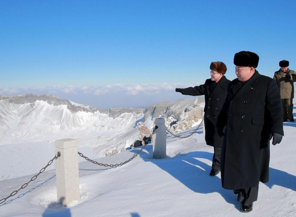  Cold un with the boys. Kim casually strolls at the summit of Mount Paektu alongside other North Korean officials