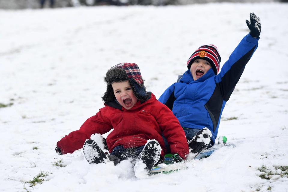  Brothers Josh and Liam Roberts have an icy blast sledging in the snow in the Brecon Beacons, South Wales