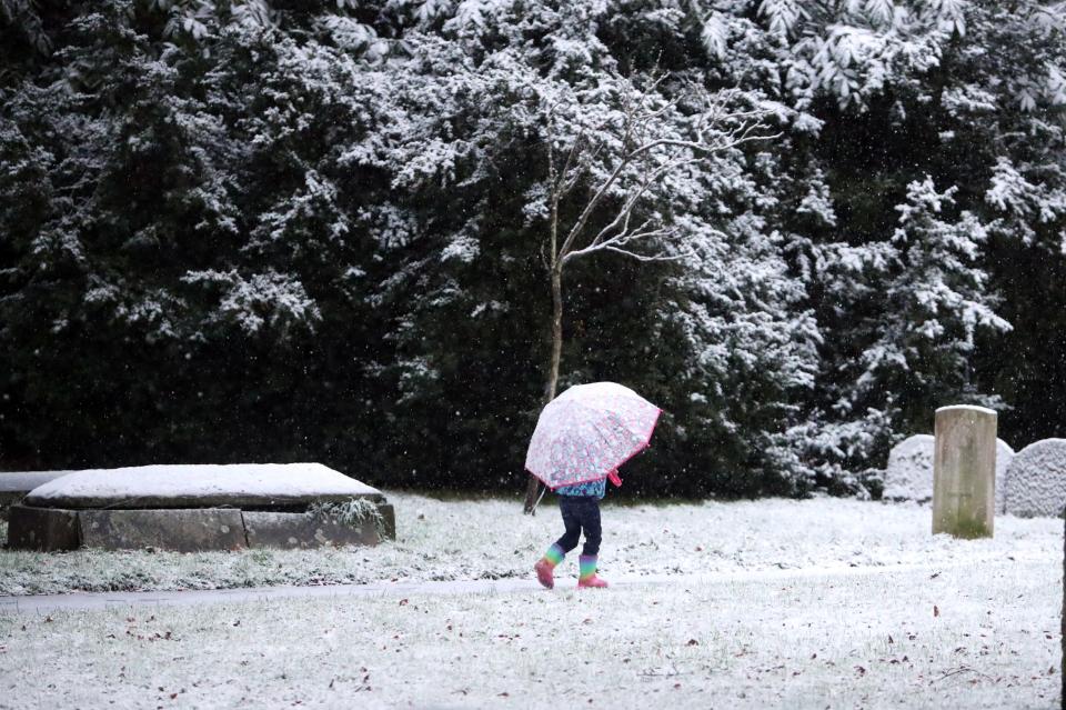  Breaking the ice! A youngster strolls through the snow in Reading, Berkshire