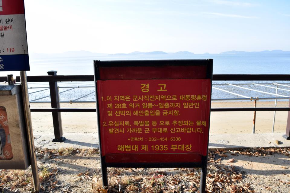  The sign reads: 'Protection against unidentified explosives (wooden box mines) We have identified several mines in this reason and we expect to see more'