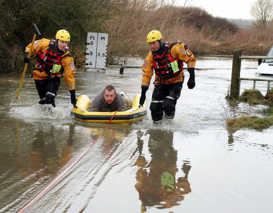  Rescuers used a rubber dinghy to haul the driver back to dry land