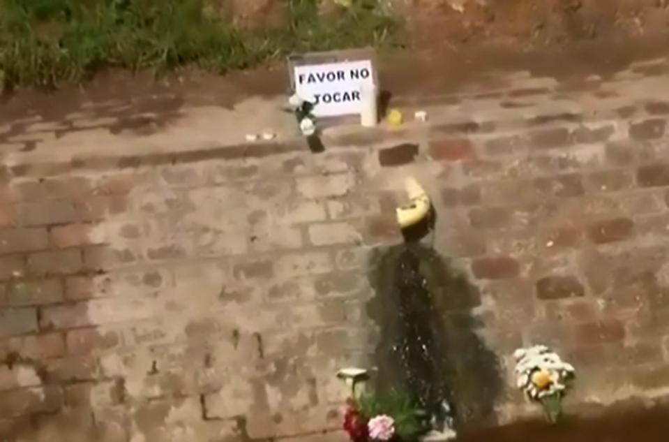  Devout Catholics left flowers and a sign asking others not to touch it