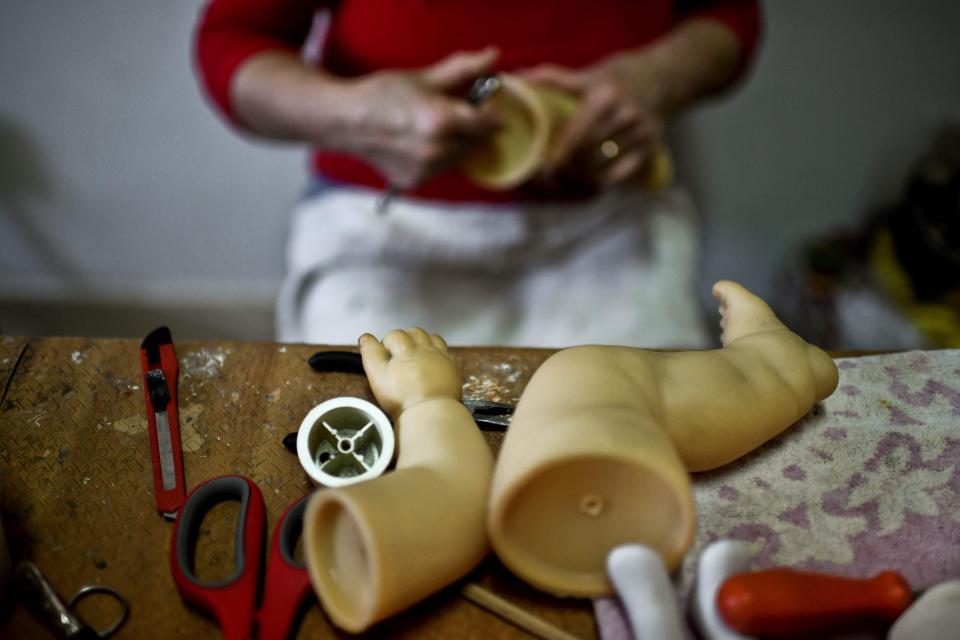  A doll surgeon gets to work on a damaged toy at the Hospital de Bonecas in Lisbon